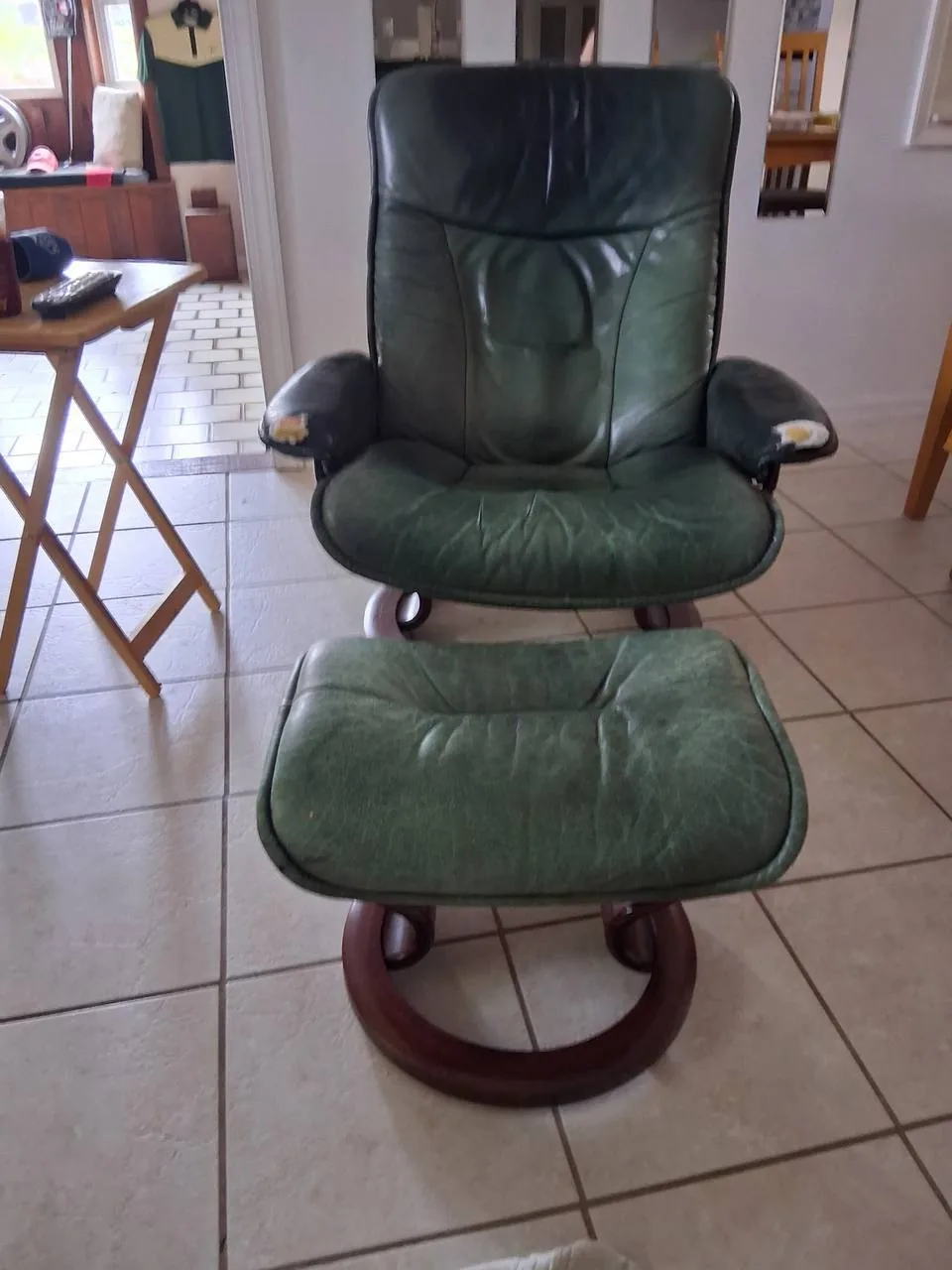 Worn green leather Stressless chair before reupholstery